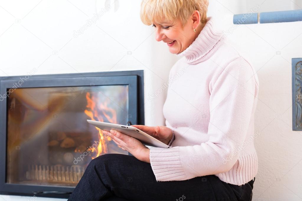 Female Senior at home in front of fireplace