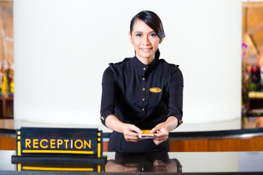 receptionist passing keycard in hotel clipart