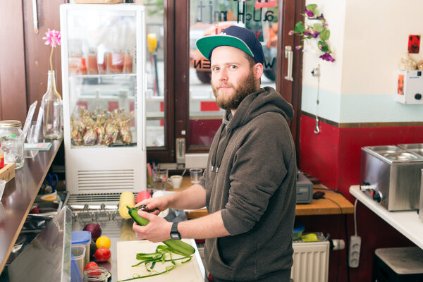 Fast food chef making hotdog in snack bar