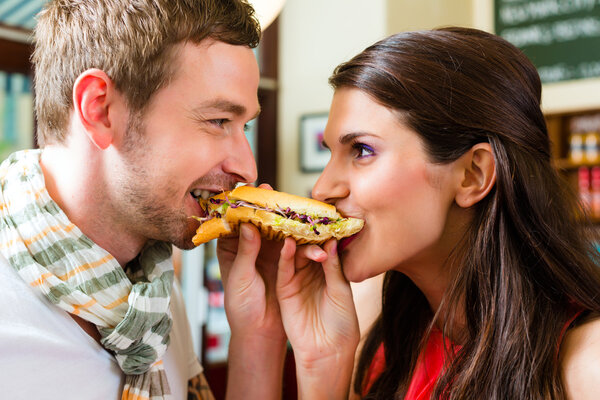 Customers eating Hotdog in fast food snack bar