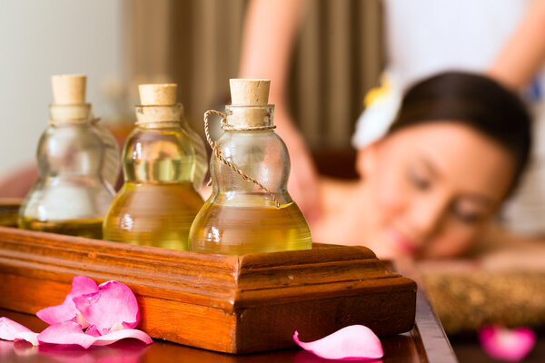 Chinese Woman at wellness massage with essential oils