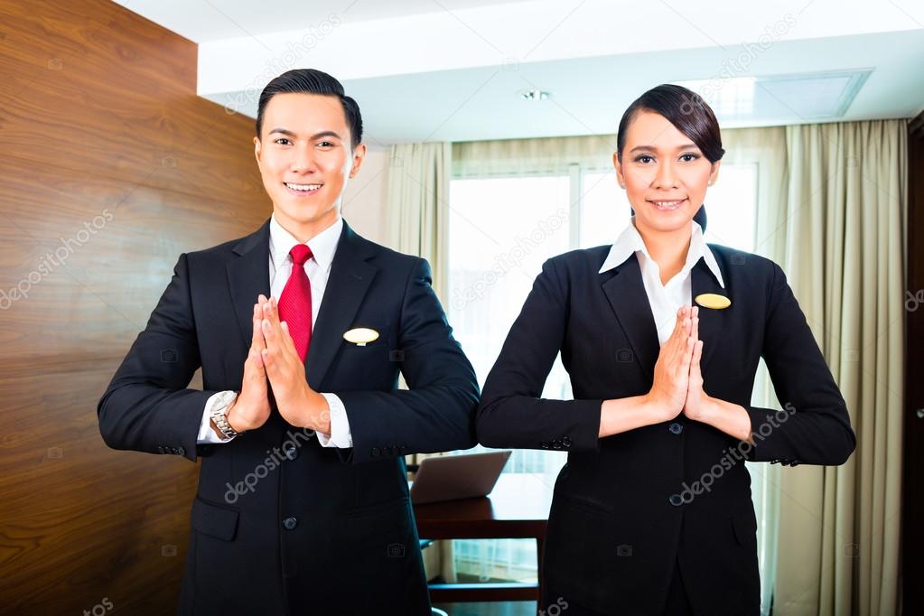 Staff greeting guests in Asian hotel