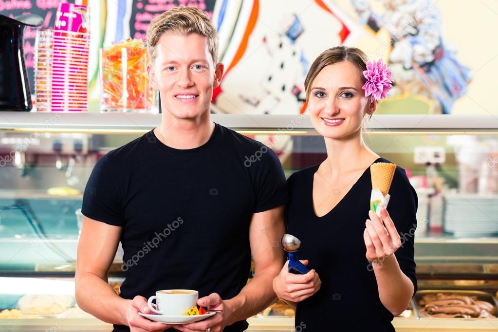 Ice cream seller and waiter working in cafe