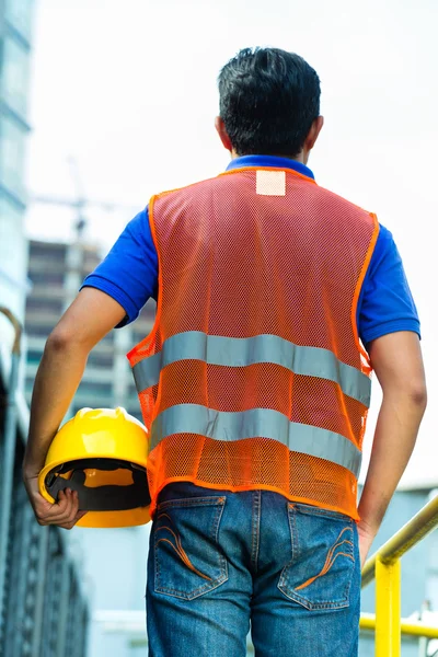 Asian Indonesian construction worker on building site