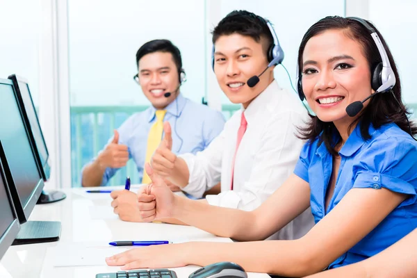 Asian Chinese call center agent team on phone