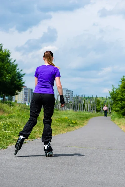 young woman skating in park