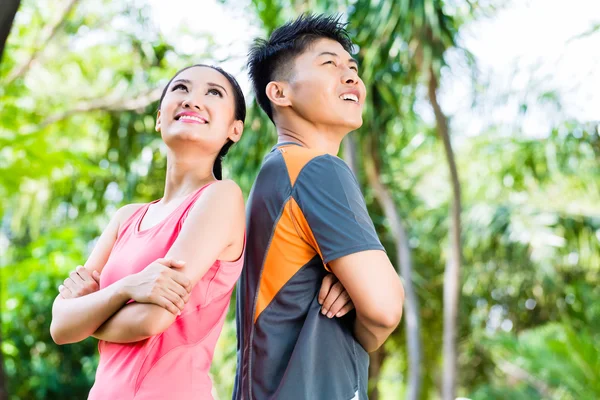 Chinese couple finish running training in park — Stock Photo, Image