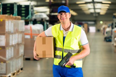 worker scans package in warehouse of forwarding