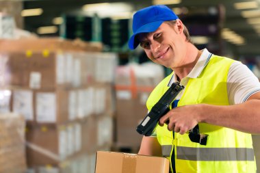worker scans package in warehouse of forwarding