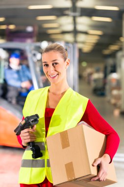 worker holds package in warehouse of forwarding