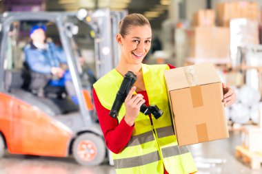 worker holds package in warehouse of forwarding clipart