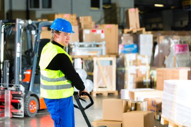 Storeman with mover at warehouse of forwarding clipart