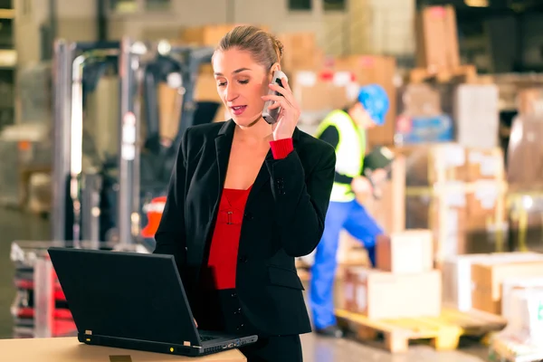 Dispatcher using phone at warehouse of forwarding — 스톡 사진