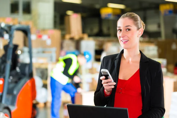 Dispatcher using phone at warehouse of forwarding — 스톡 사진