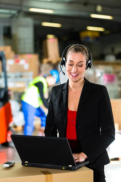 Dispatcher using headset at warehouse of forwarding — Stock Photo, Image