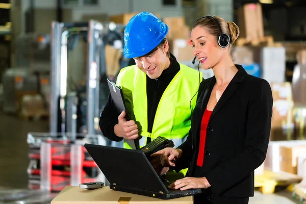 Coworkers at warehouse of forwarding company — Stock Photo, Image