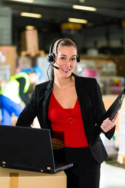 Dispatcher using headset at warehouse of forwarding — Stock Photo, Image