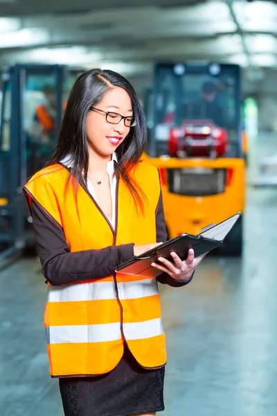 Female employee or supervisor at warehouse — Stock Photo, Image