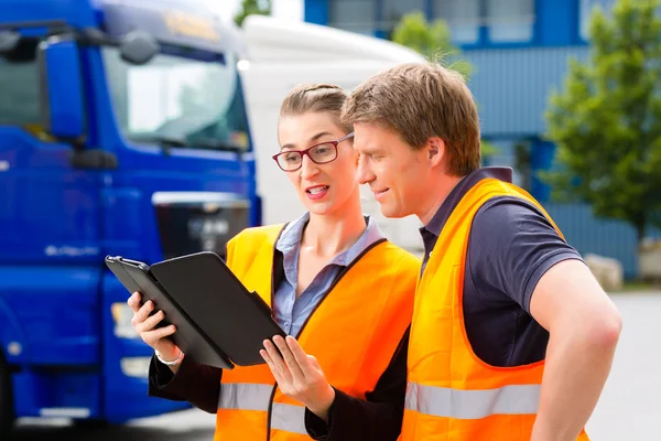 Forwarder in front of trucks on a depot — Stock Photo, Image