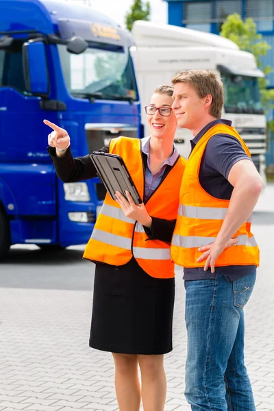 Forwarder in front of trucks on a depot — Stock Photo, Image