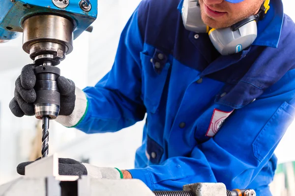 Craftsman drilling metal with drill — Stock Photo, Image