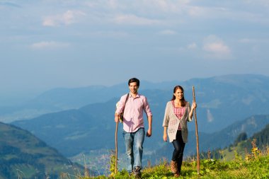 Hiking vacation - man and woman in alp mountains