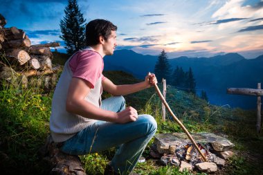 Alps - Man at campfire in Bavarian mountains