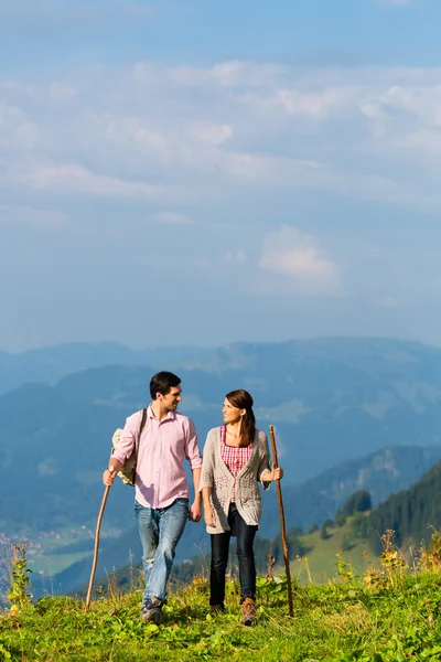 Hiking vacation - man and woman in alp mountains — Stockfoto