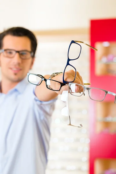 Joven en óptico con gafas — Foto de Stock