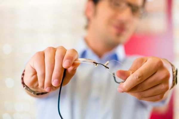 Ung mand hos optiker med briller - Stock-foto