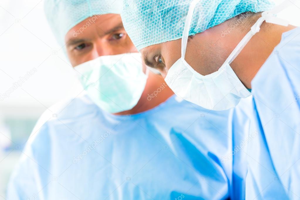 Surgeons or doctors in operating room of hospital