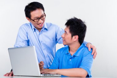 Asian father and son learning at home for school clipart