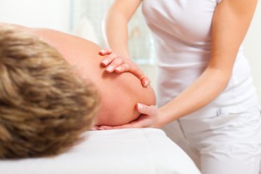 Patient at the physiotherapy - massage clipart