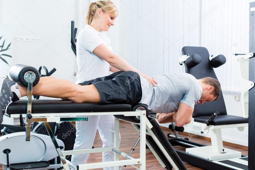 Physiotherapist or sport doctor with patient