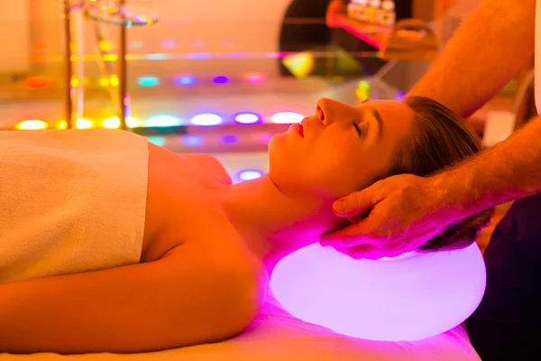 Vrouw genieten van therapie in spa met kleur therapie — Stockfoto