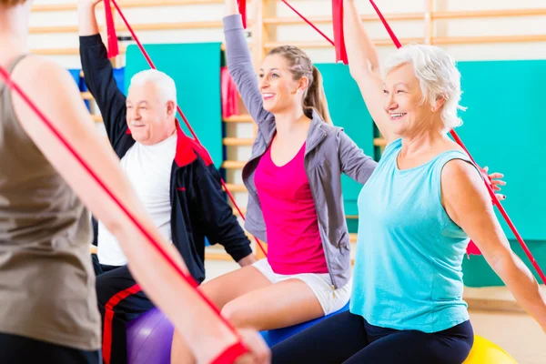 Senior people at fitness course in gym