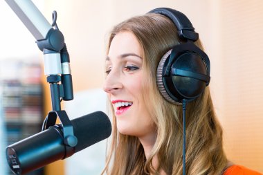 Female radio presenter in radio station on air clipart