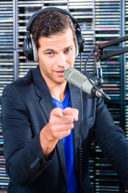 Male radio presenter in radio station on air clipart