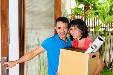 Asian couple moving in the new home clipart