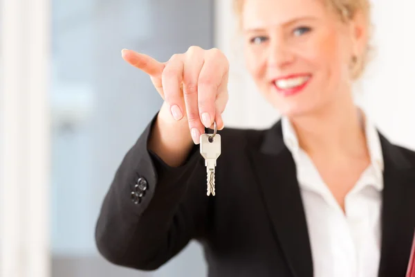 Young realtor is with keys in an apartment — Stock Photo, Image