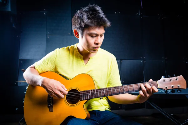 Guitarrista asiático tocando música en estudio de grabación — Foto de Stock