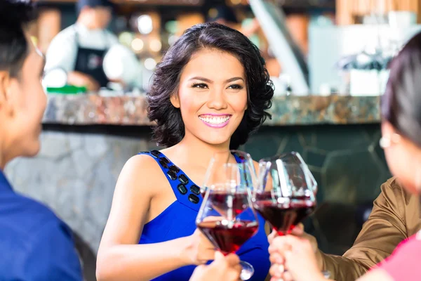 Amigos asiáticos brindando con vino en restaurante — Foto de Stock