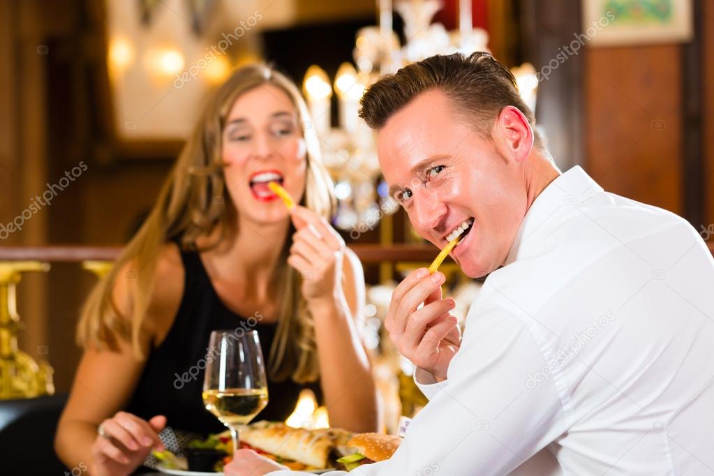 happy couple in restaurant eat fast food