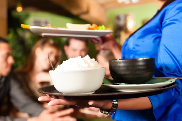 People with waitress eating in Thai restaurant — Zdjęcie stockowe