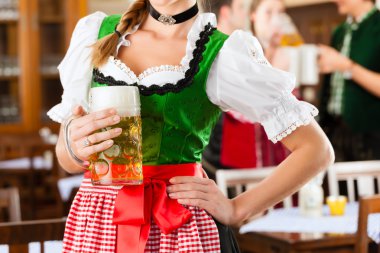 people in traditional Bavarian Tracht in restaurant or pub