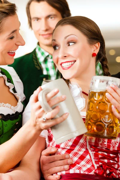 People in traditional Bavarian Tracht in restaurant or pub — Stockfoto