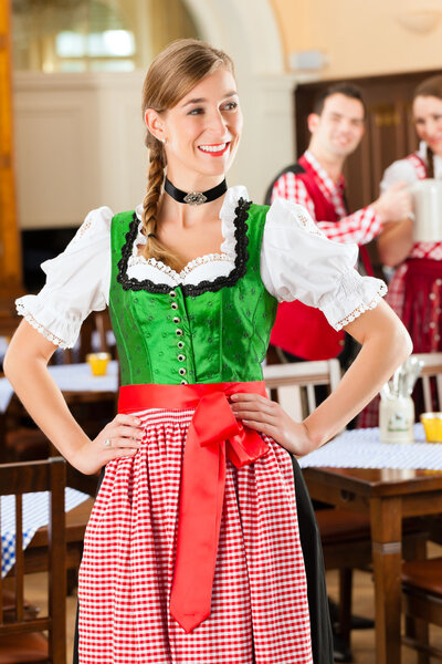 people in traditional Bavarian Tracht in restaurant or pub