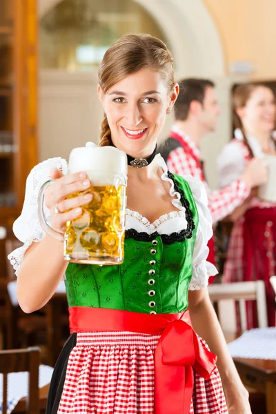 People in traditional Bavarian Tracht in restaurant or pub — Stockfoto