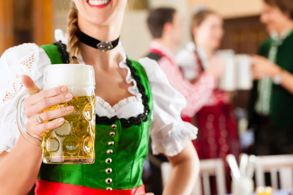 People in traditional Bavarian Tracht in restaurant or pub — 图库照片