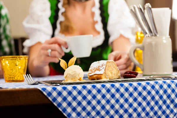 Woman in traditional Bavarian Tracht in restaurant or pub — стокове фото